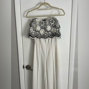 White jumpsuit with black and white floral decorations